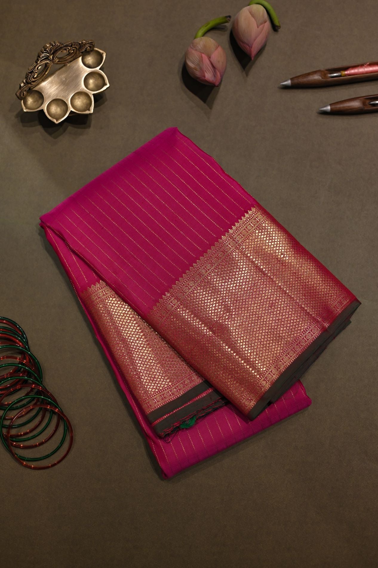 Broad border pink Kanchivaram silk saree with green blouse