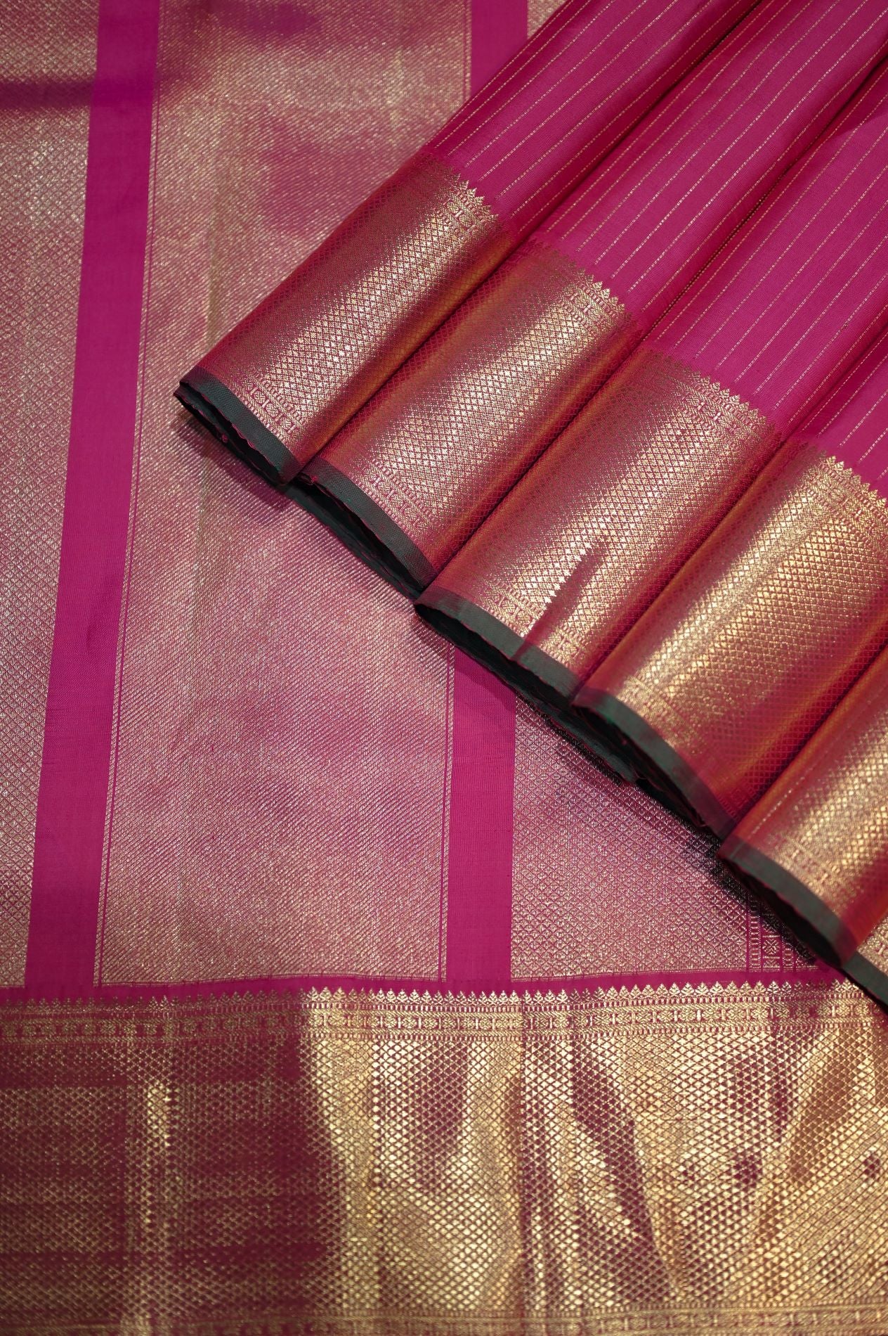 Broad border pink Kanchivaram silk saree with green blouse